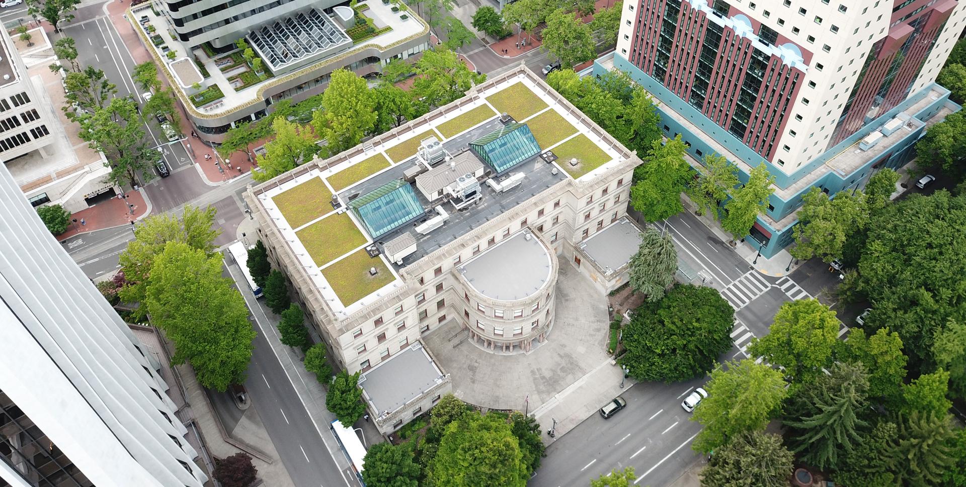 Aerial view of Portland City Hall with its green roof visible in the downtown context.